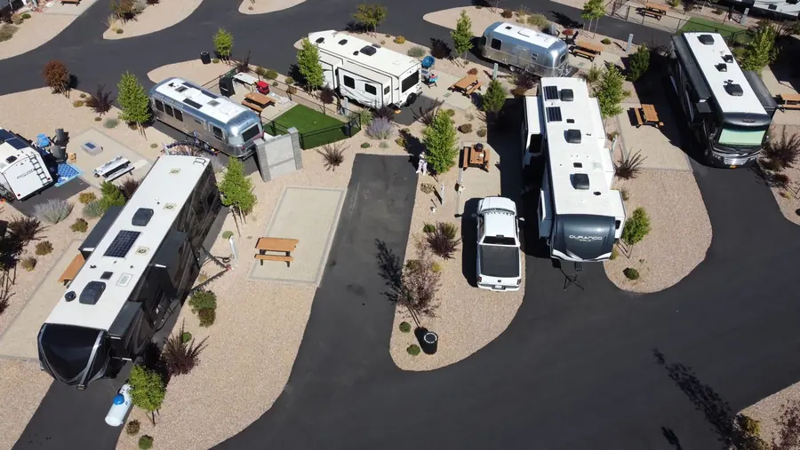 Aerial view of a modern RV park with fifth-wheel trailers, Airstreams and motorhomes on gravel pads